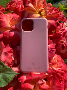 Compostable & Co. iPhone 11 pink biodegradable phone case with roses in the background