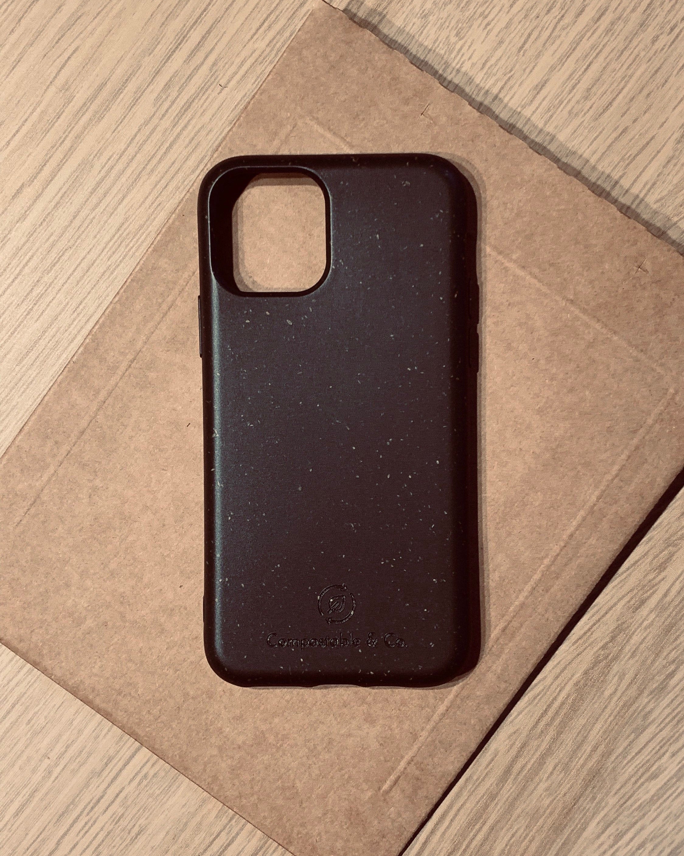 Compostable & Co. iPhone 11 pro max black biodegradable phone case with recycled paper background