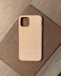 Compostable & Co. iPhone 11 pro yellow biodegradable phone case with recycled paper background
