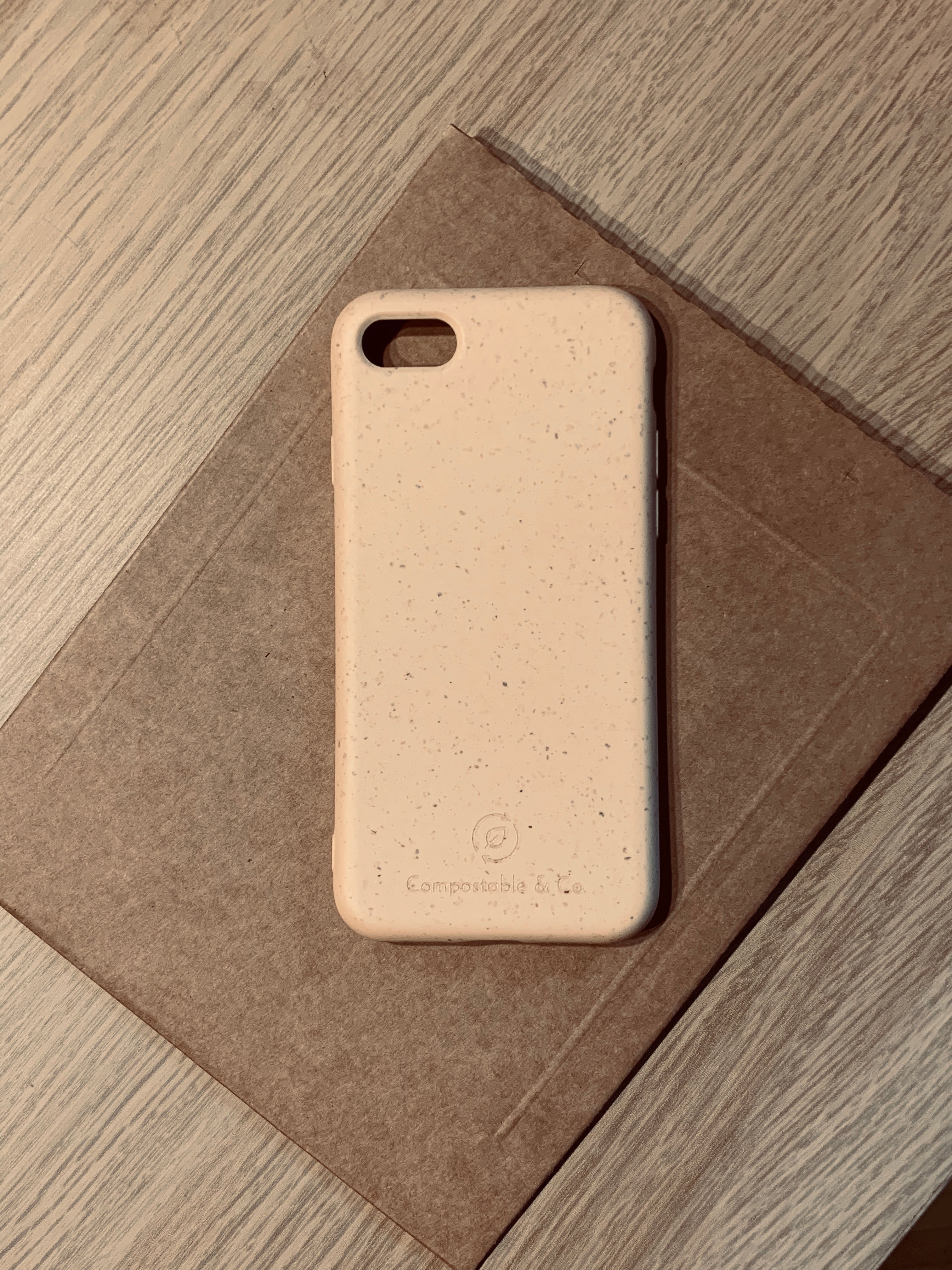 Compostable & Co. iPhone 7 / 8 / SE 2020 yellow biodegradable phone case with recycled paper background