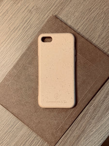 Compostable & Co. iPhone 7 / 8 / SE 2020 yellow biodegradable phone case with recycled paper background